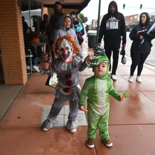 Children posing in costumes for the Main Street Boo Review